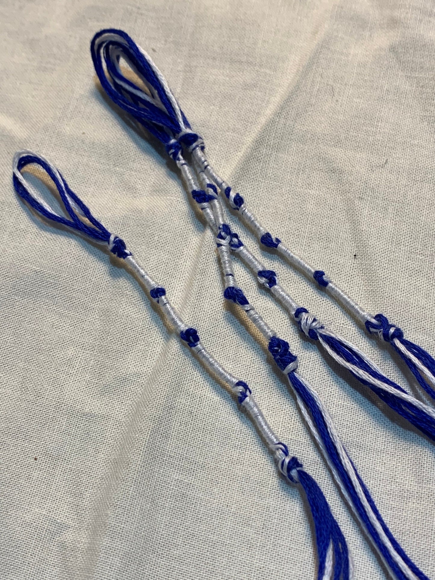 Four-piece tzit-zit set displayed on beige background by The Family of Yah