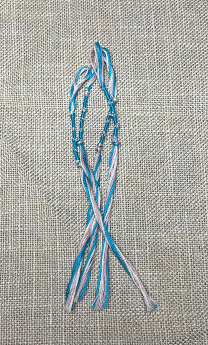 Close-up of blue and pink cotton tassel with blue cord detail by the Family of Yah