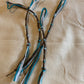 Dark brown tzitzit tassel with blue cord detail